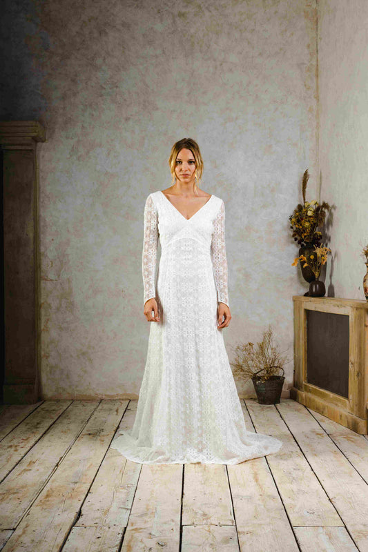 model wearing a modern bohemian lace wedding dress with sleeves