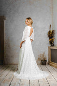 Load image into Gallery viewer, model wearing a modern bohemian lace wedding dress with bell sleeves