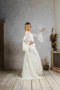 Load image into Gallery viewer, model wearing a modern bohemian lace wedding dress with bell sleeves