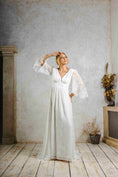 Load image into Gallery viewer, model wearing an outdoors wedding dress with sleeves