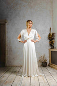 Load image into Gallery viewer, Model wearing a vintage-inspired wedding dress with sleeve slits.