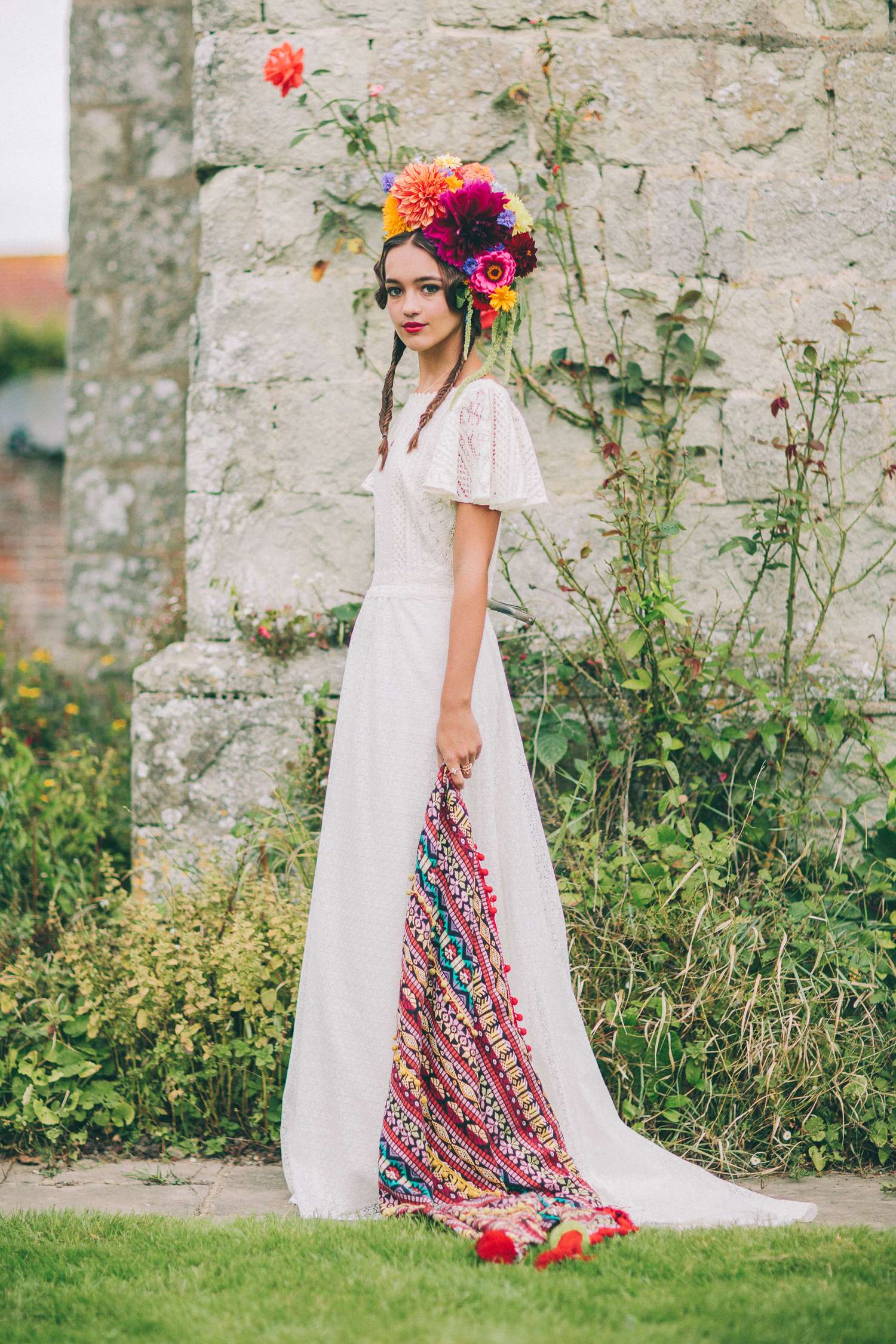 Bride wearing a Frida Kahlo inspired flower headdress and a lace wedding dress.