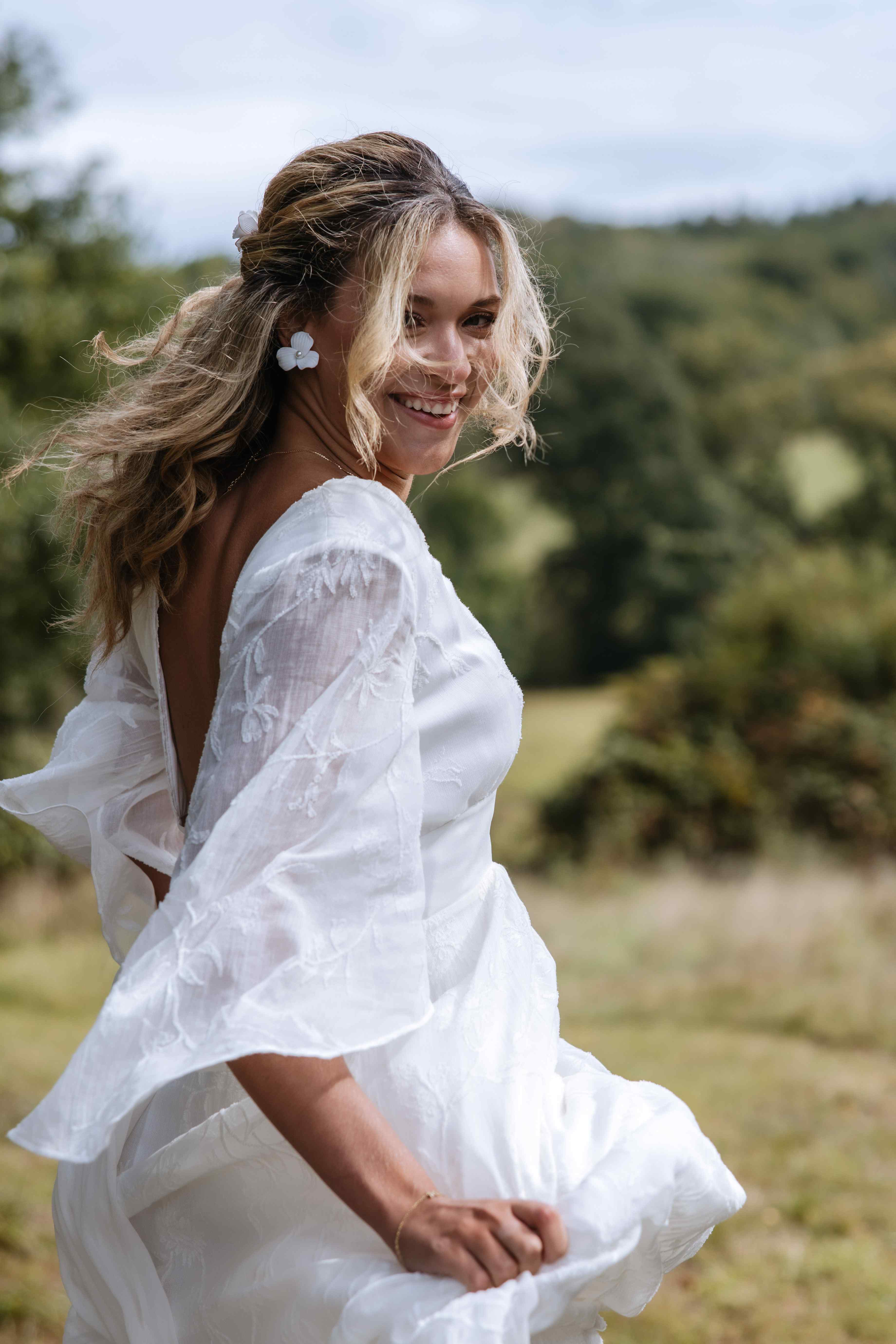 Boho bride running and looking back to the camera.