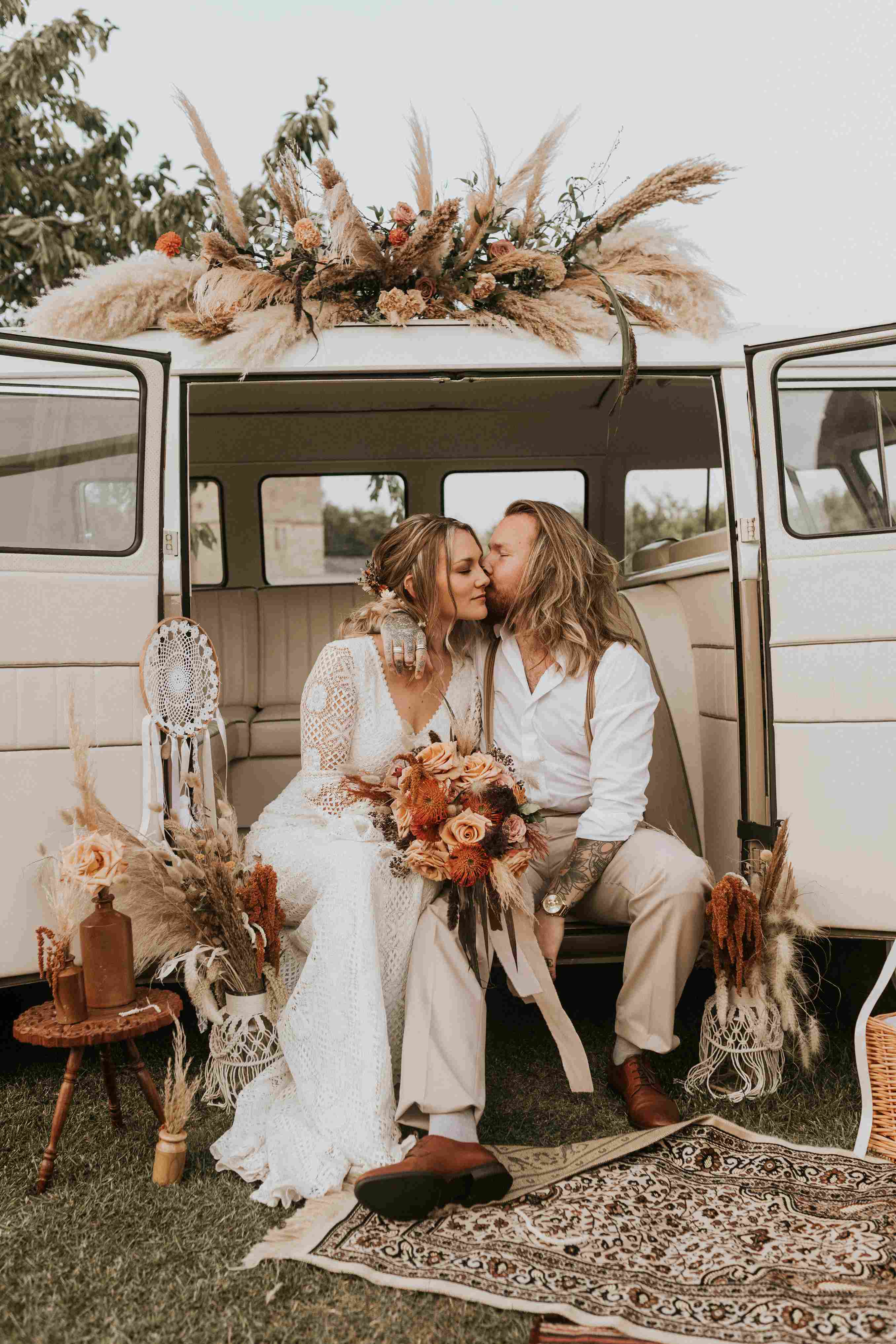 bride and groom sitting in a camper van