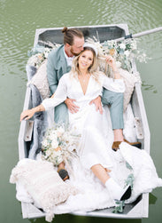 boho bride and groom in a boat