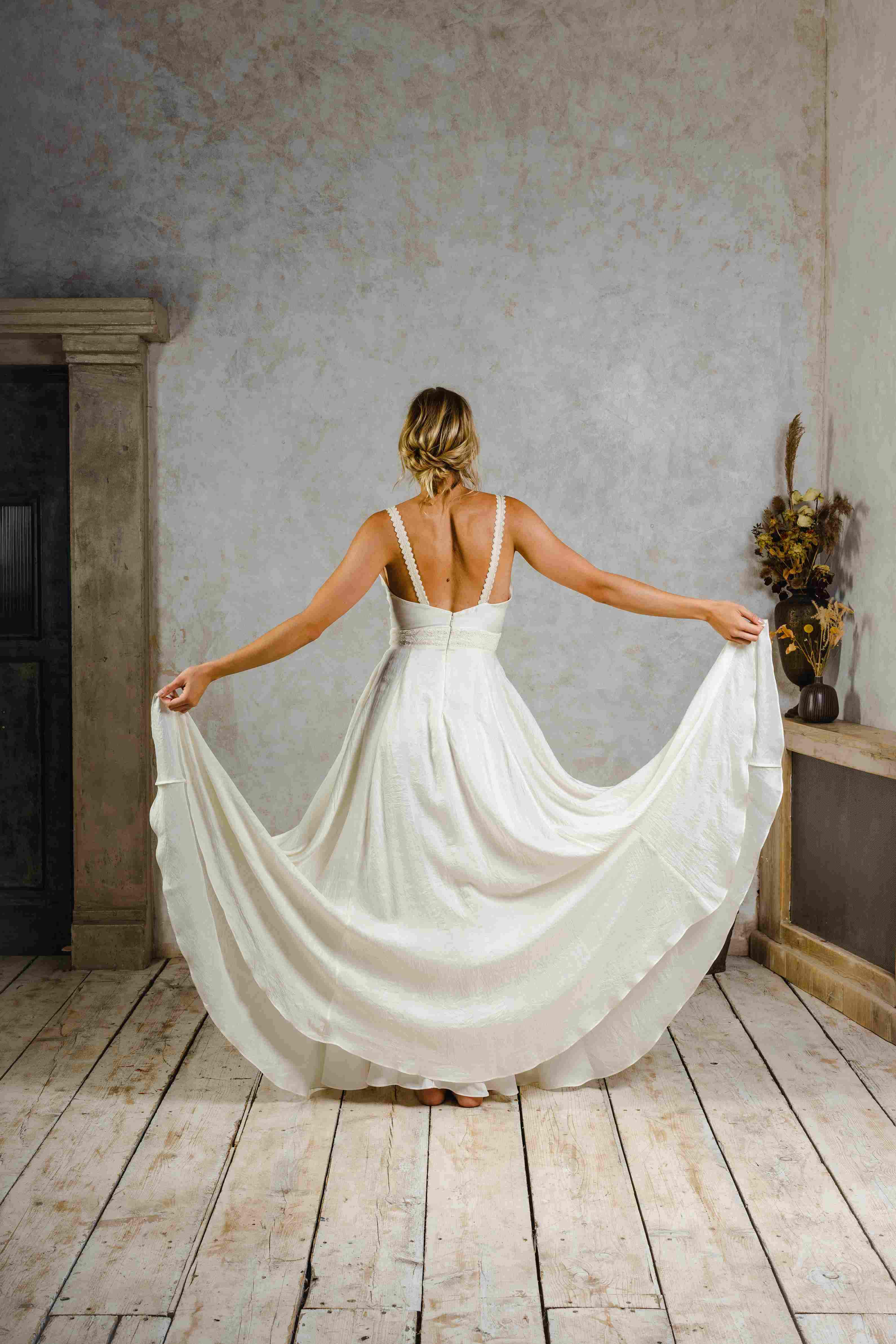 Model wearing a boho silk wedding dress with big skirt.
