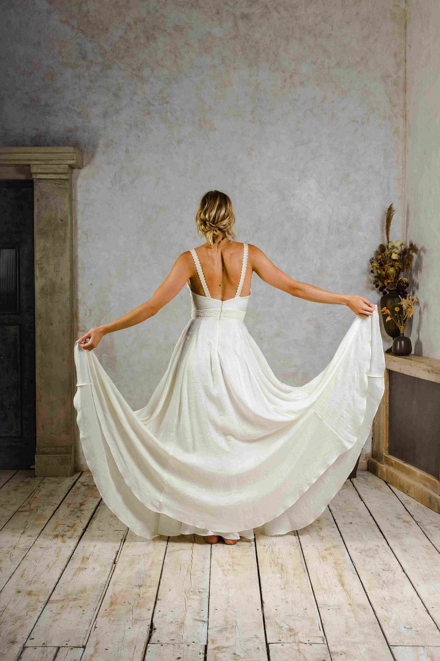 Model wearing a boho silk wedding dress with big skirt.