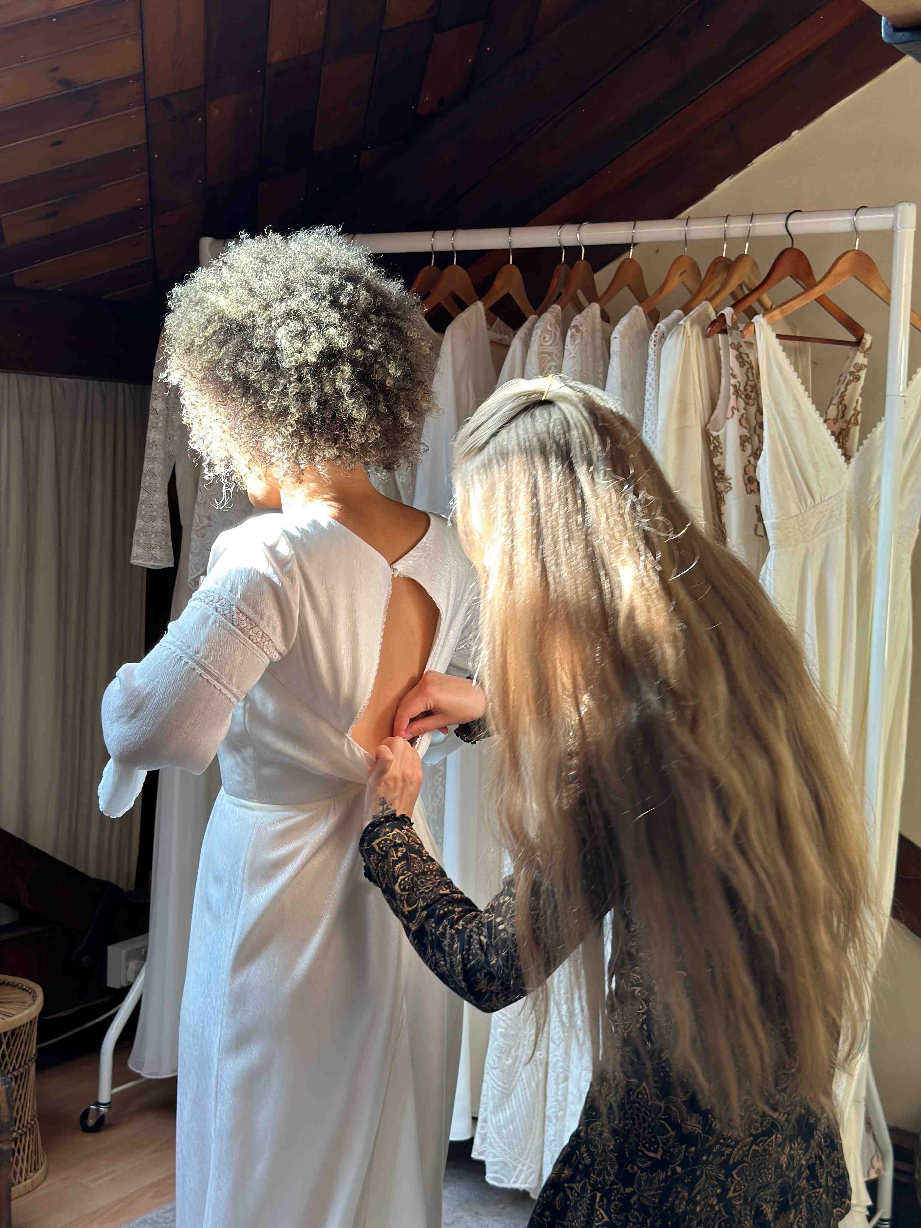 bridal consultant adjusting a wedding dress