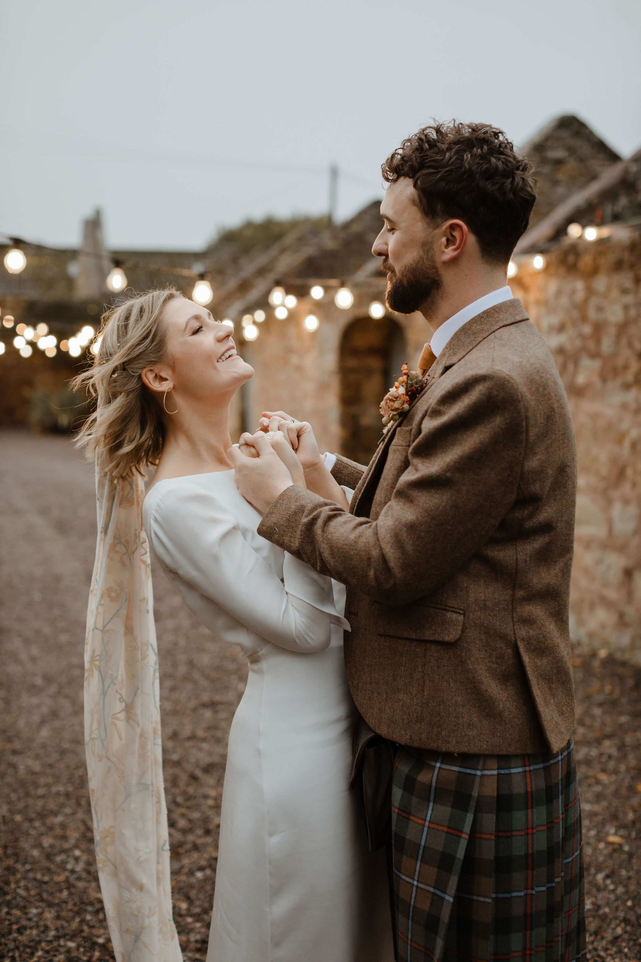 Bride and groom holding hands on their wedding day.