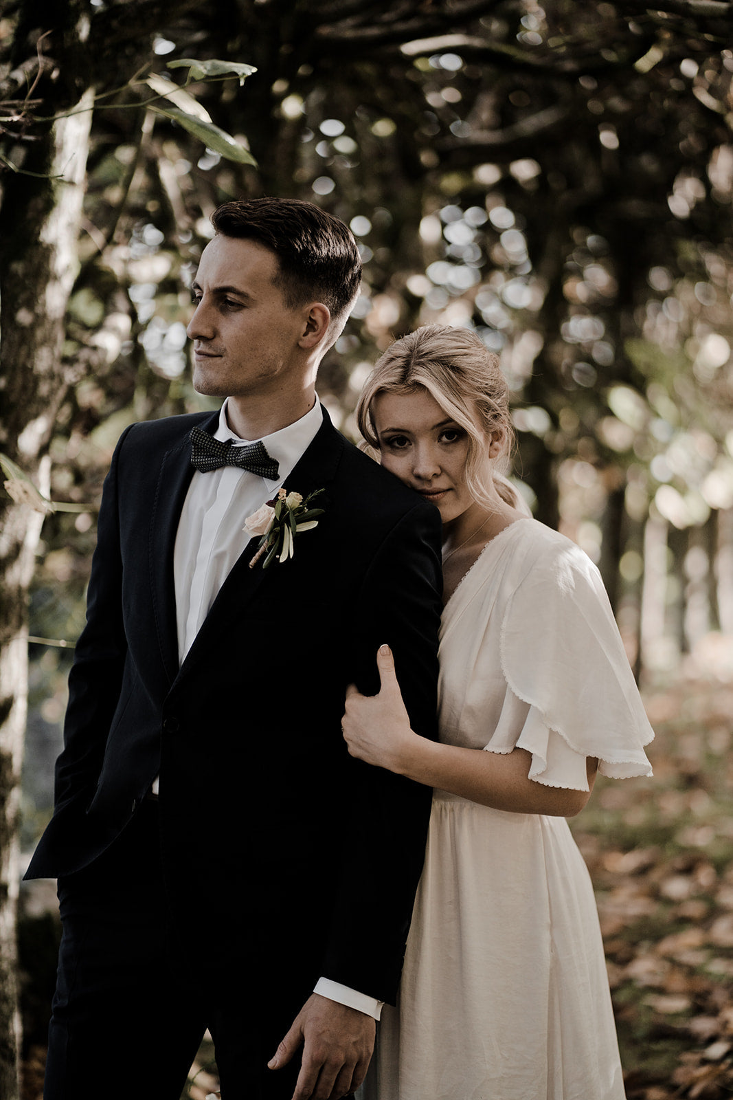 bride and groom embracing during their autumn wedding