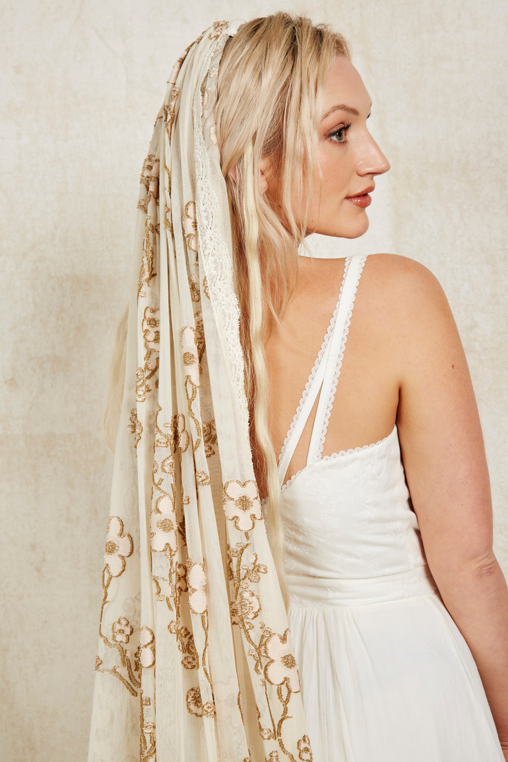 bride wearing a colourful veil with cherry blossoms