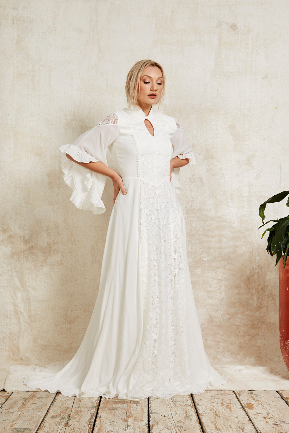 Woman wearing a cowgirl inspired wedding dress with sleeves.
