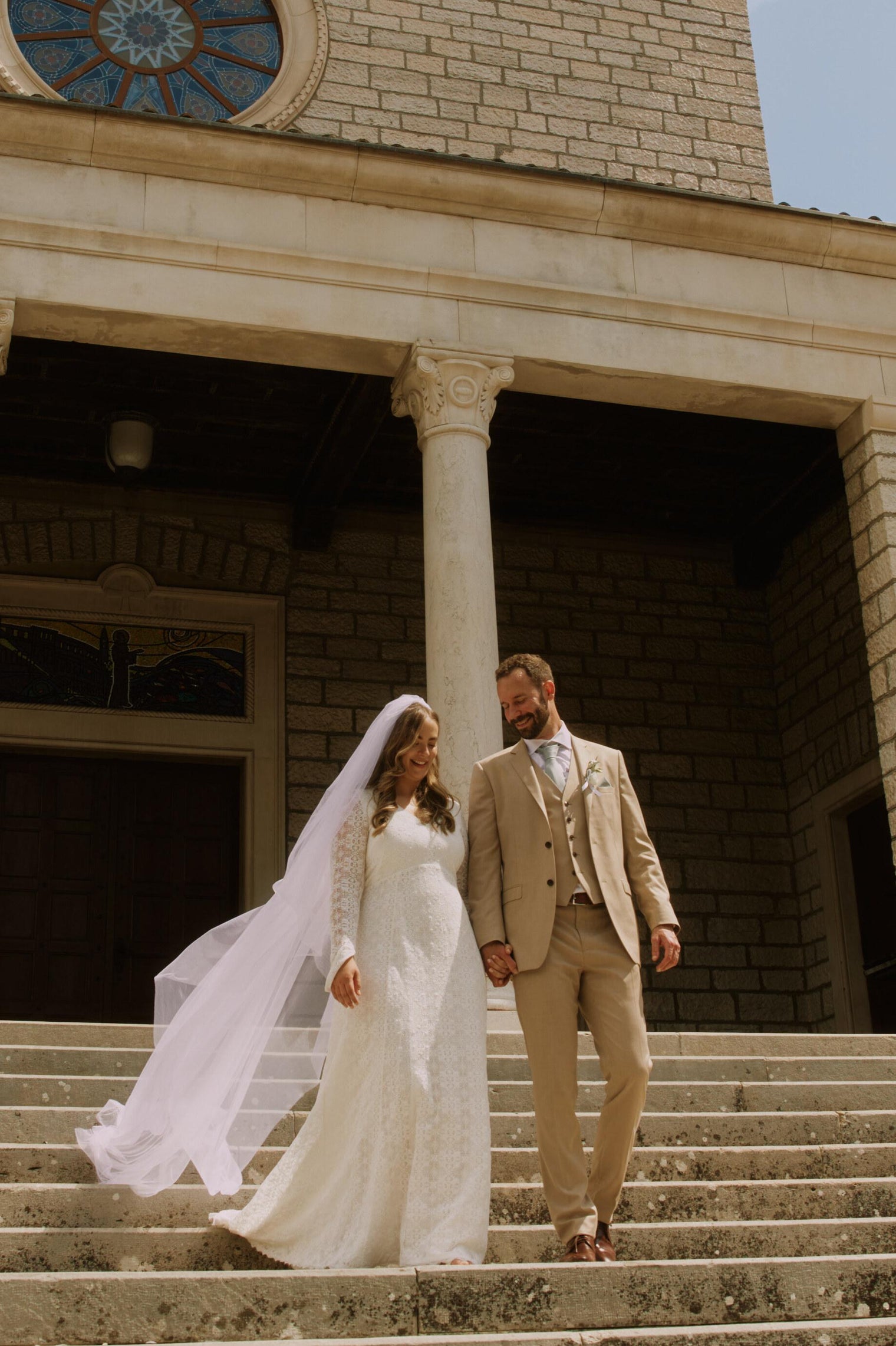 bride and groom coming down stairs