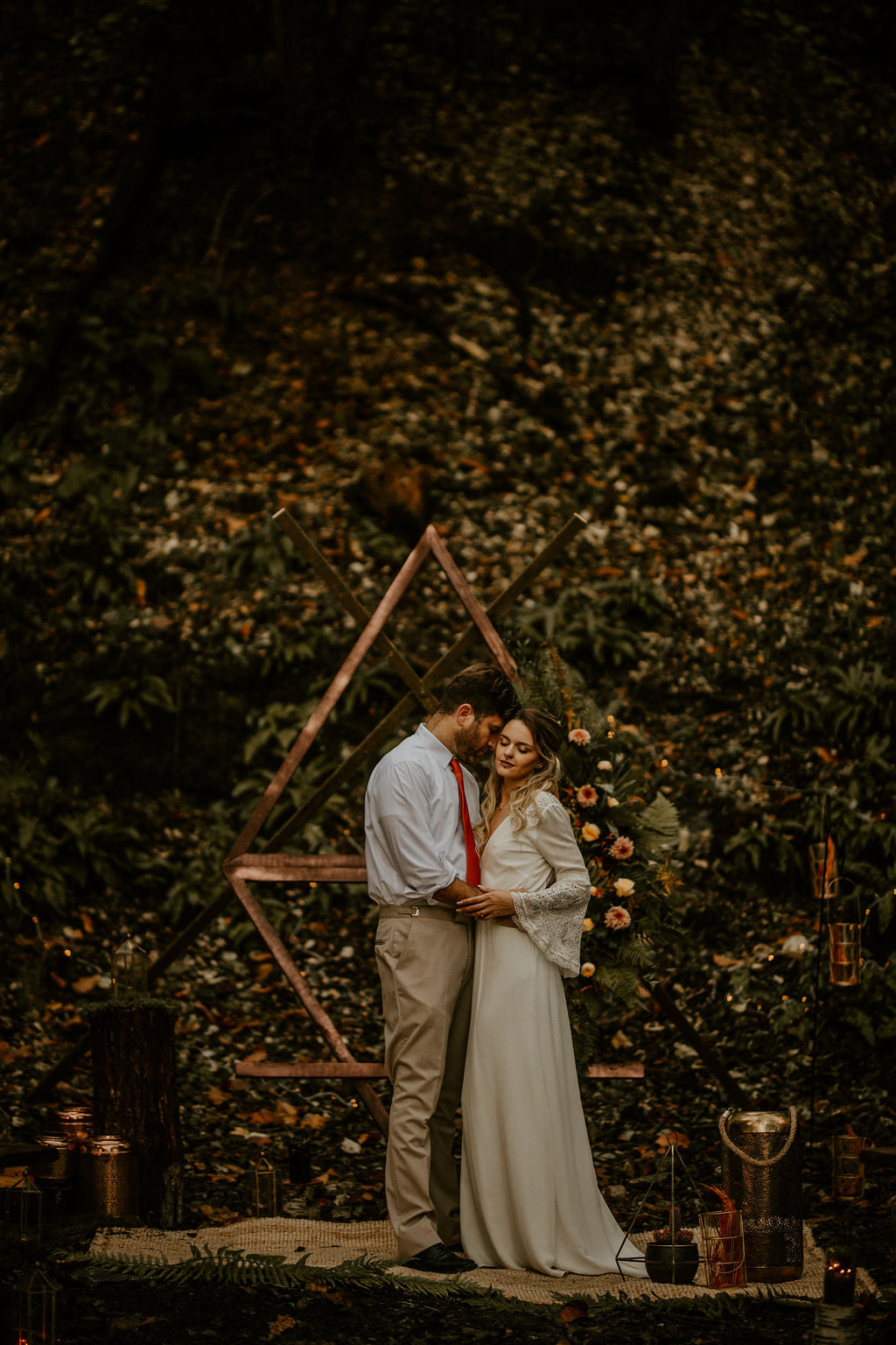 bride and groom embracing at the end of the aisle at their elemental wedding