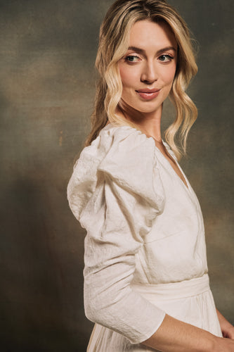 model wearing a linen wedding dress with a puffy sleeve