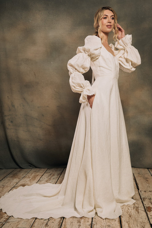 model wearing a linen wedding dress with cool sleeves