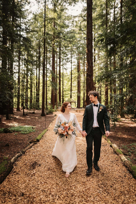 bride and groom walking down the aisle at their rustic woodland wedding