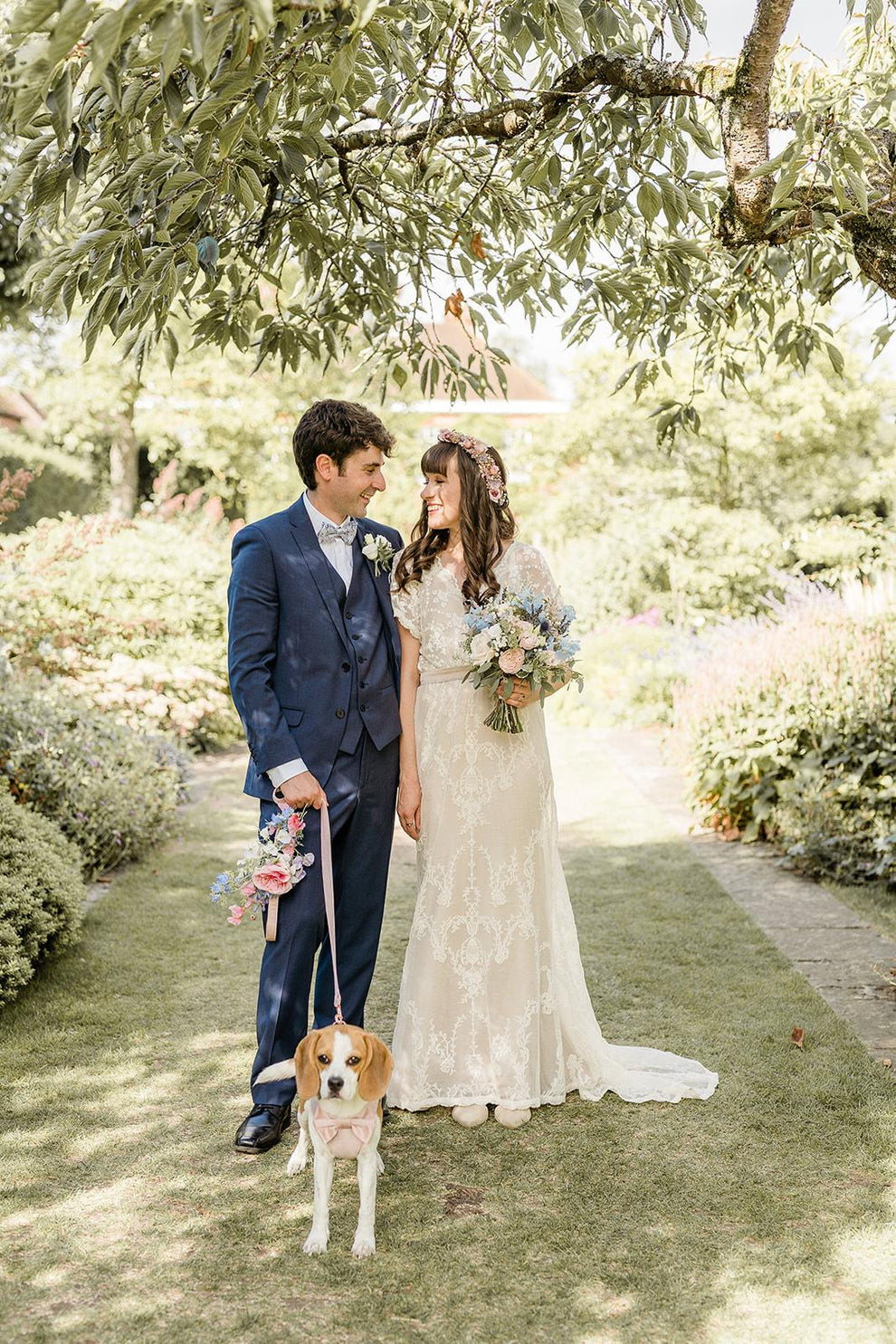 bohemian bride and room standing with their cute dog