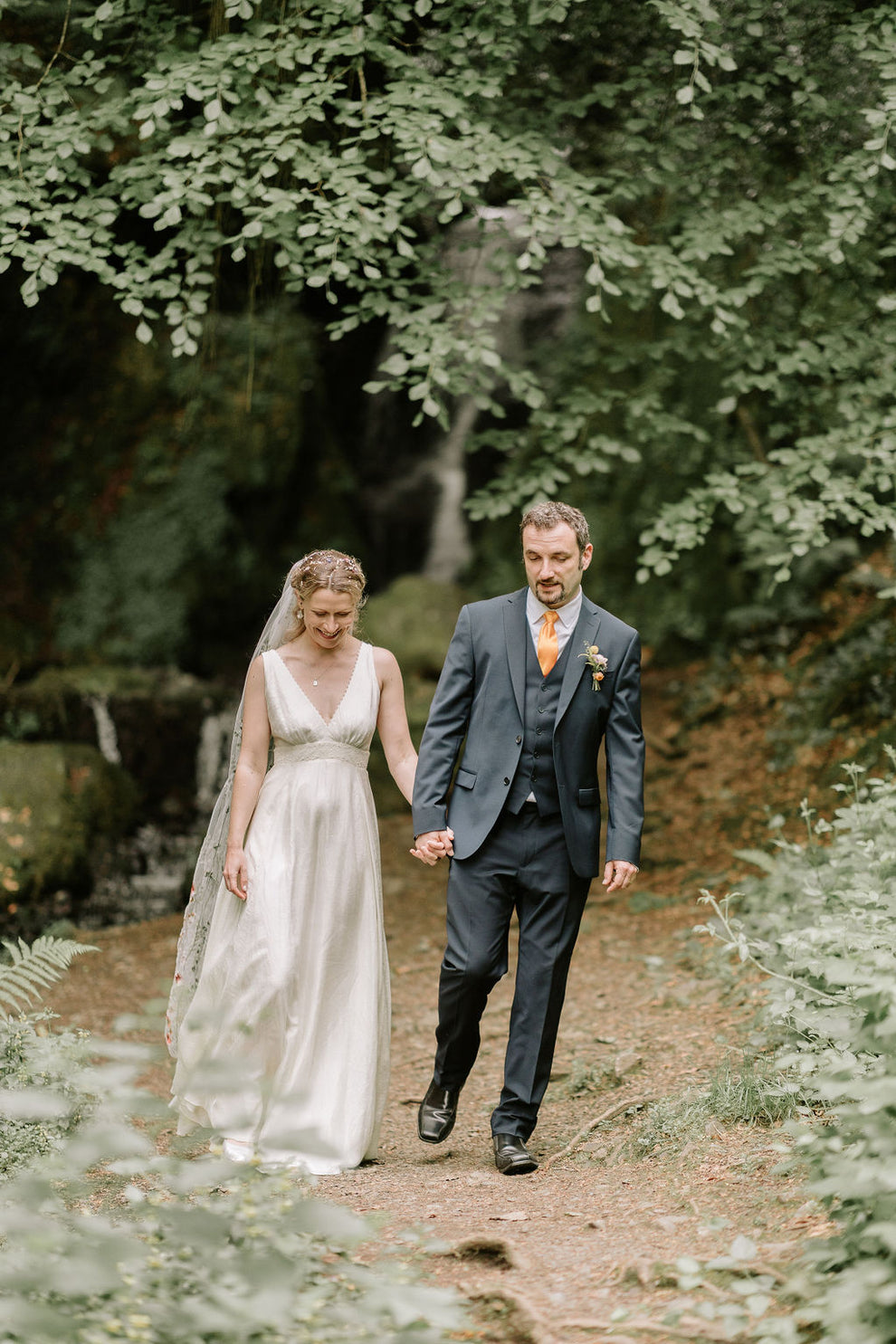 bride and groom walking hand in hand