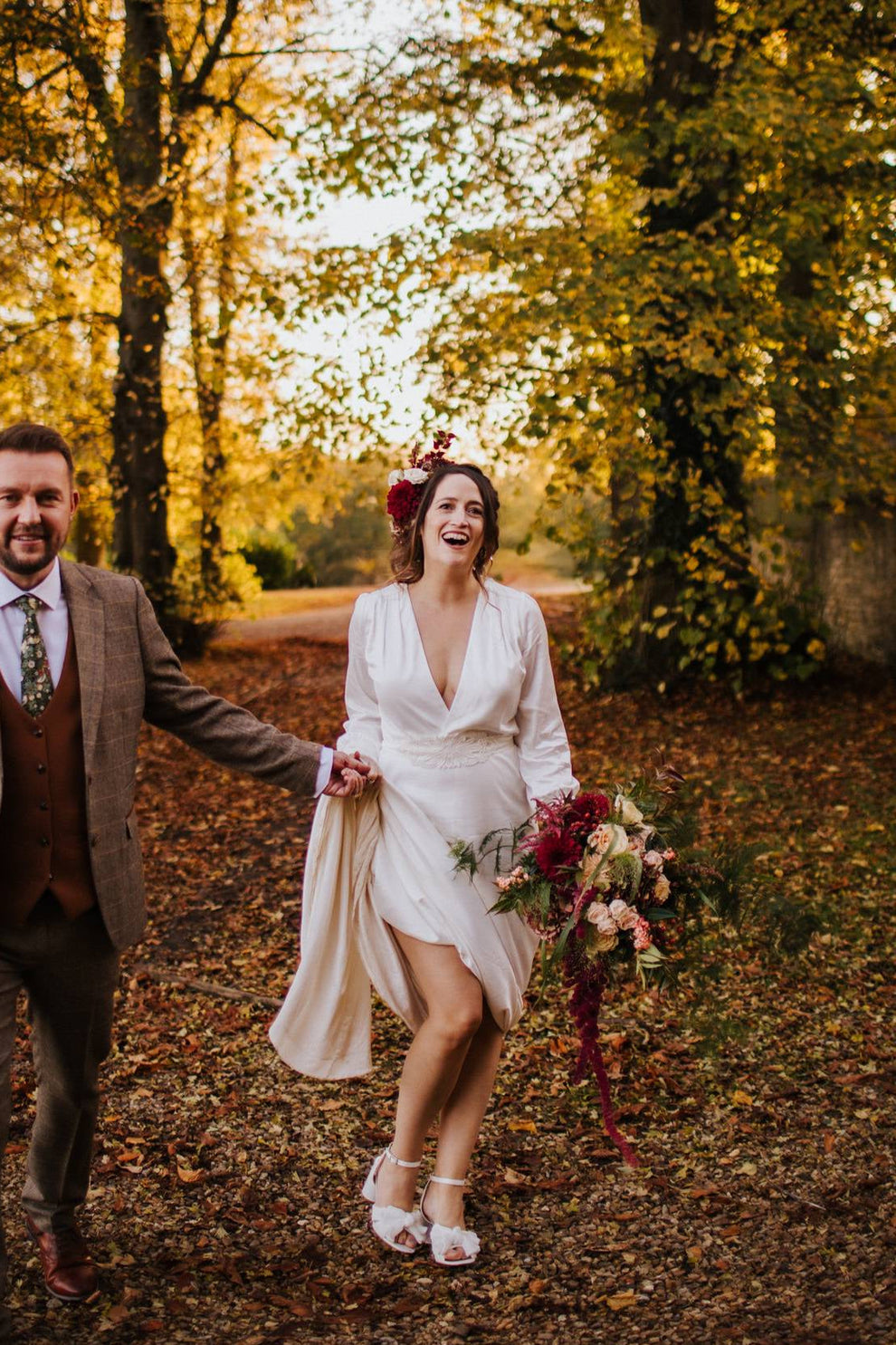 bride and groom walking in a forest