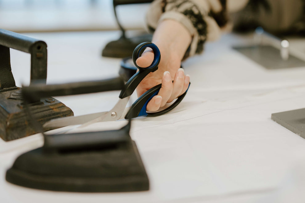 dressmaker cutting a wedding dress