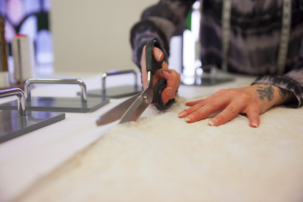 dressmaker cutting a wedding dress