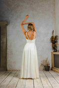 Load image into Gallery viewer, model wearing a flowy silk summer dress with a voluminous skirt
