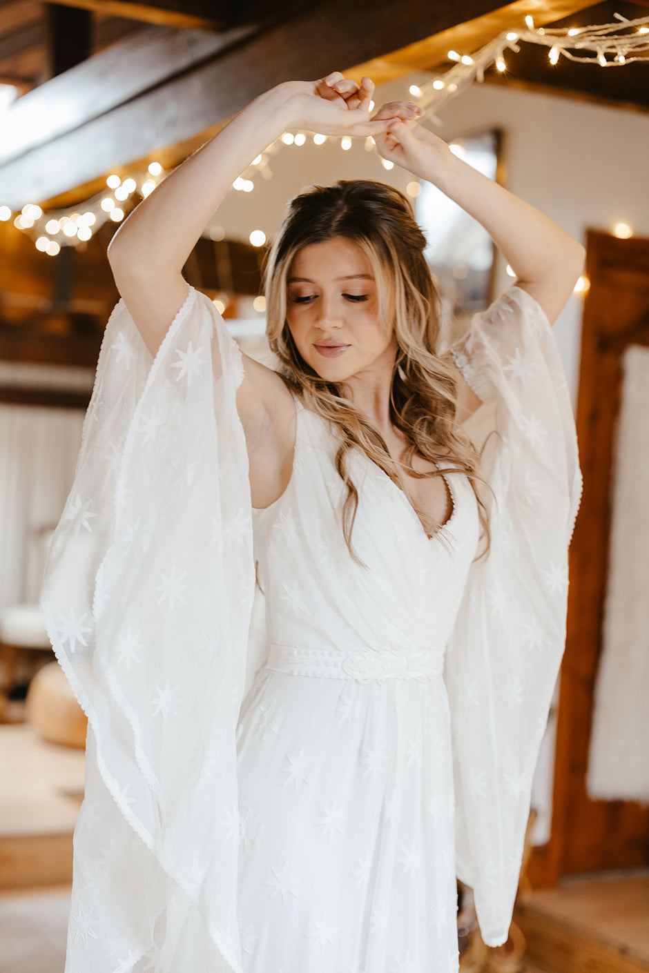 bride wearing a bohemian lace wedding dress with big sleeves