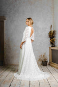 Load image into Gallery viewer, model wearing a modern bohemian lace wedding dress with bell sleeves
