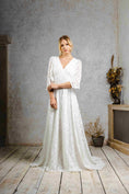 Load image into Gallery viewer, model wearing a modern bohemian lace wedding dress with bell sleeves
