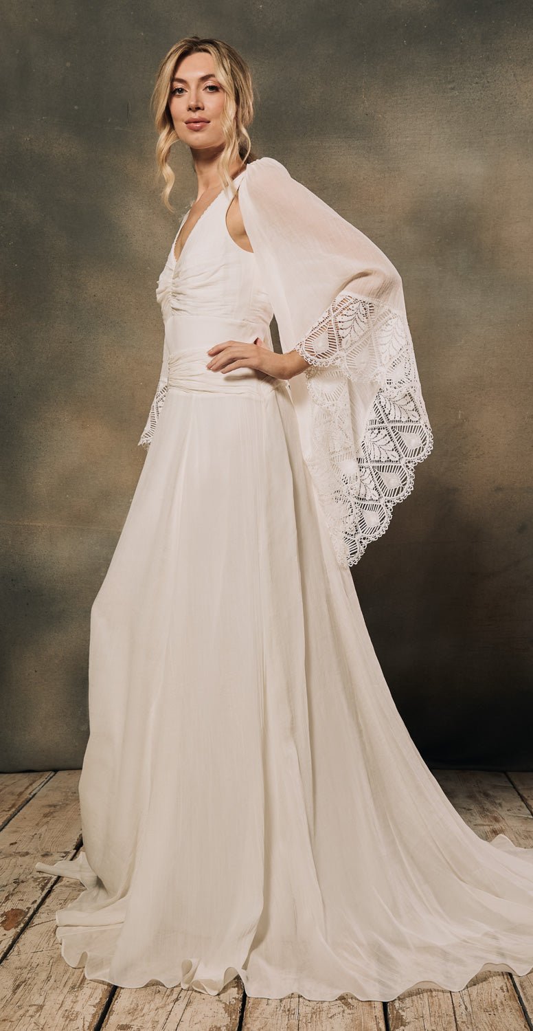 model wearing a comfortable modern bohemian wedding dress with big detachable angel sleeves made from sustainable materials