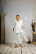 Load image into Gallery viewer, model wearing an outdoors wedding dress with sleeves
