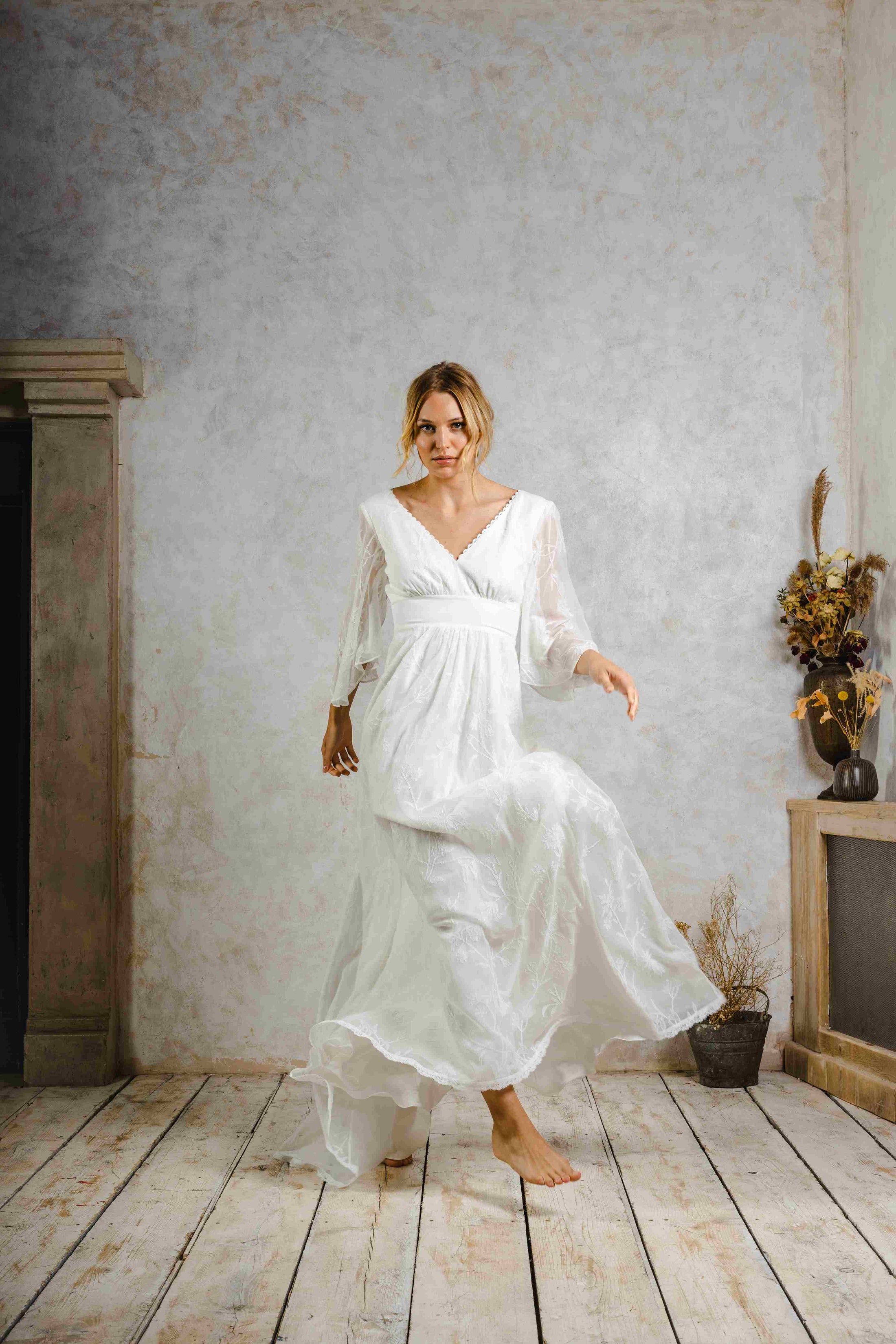 model wearing an outdoors wedding dress with sleeves