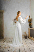 Load image into Gallery viewer, model wearing an outdoors wedding dress with sleeves
