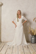 Load and play video in Gallery viewer, model wearing a fitted lace wedding dress with pointy sleeves
