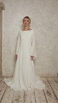 Load and play video in Gallery viewer, model wearing a linen wedding dress with a boat neckline and bell sleeves
