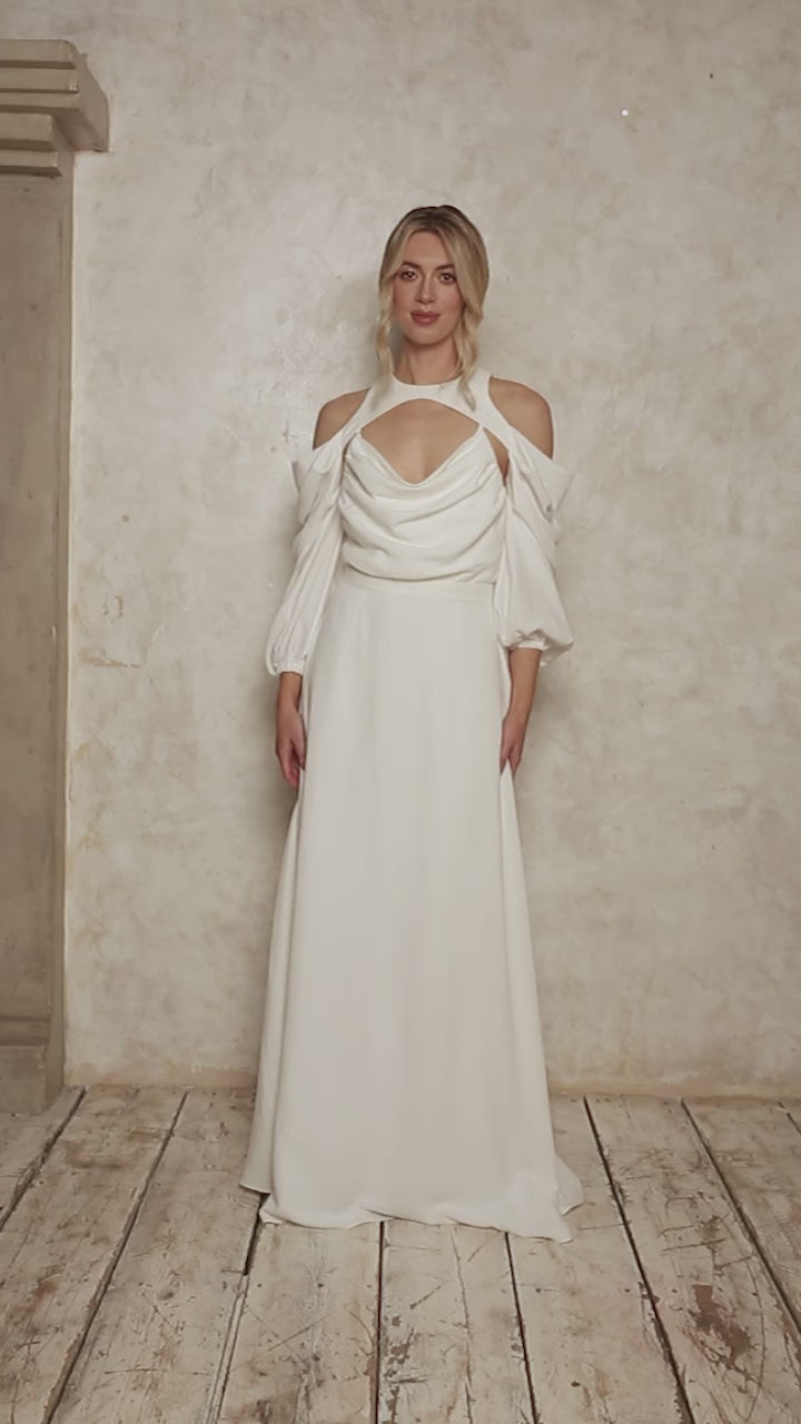 model wearing a wedding dress with a cowl neckline and billowy sleeves