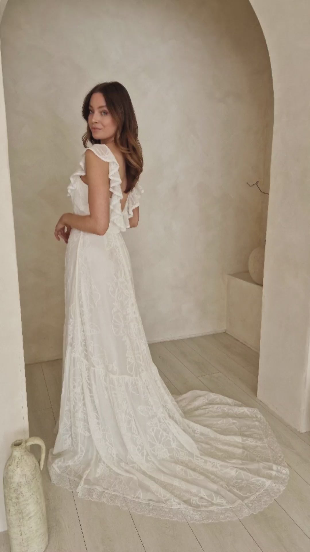 A model wearing a romantic lace wedding dress.
