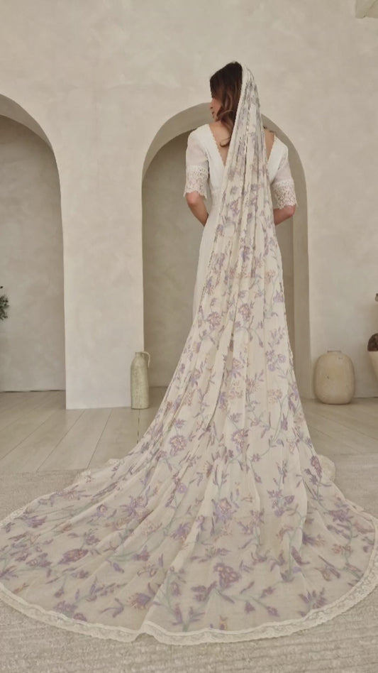 A model wearing a colourful floral wedding veil.