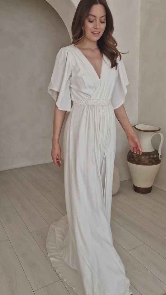 A model wearing a modern bohemian wedding dress.