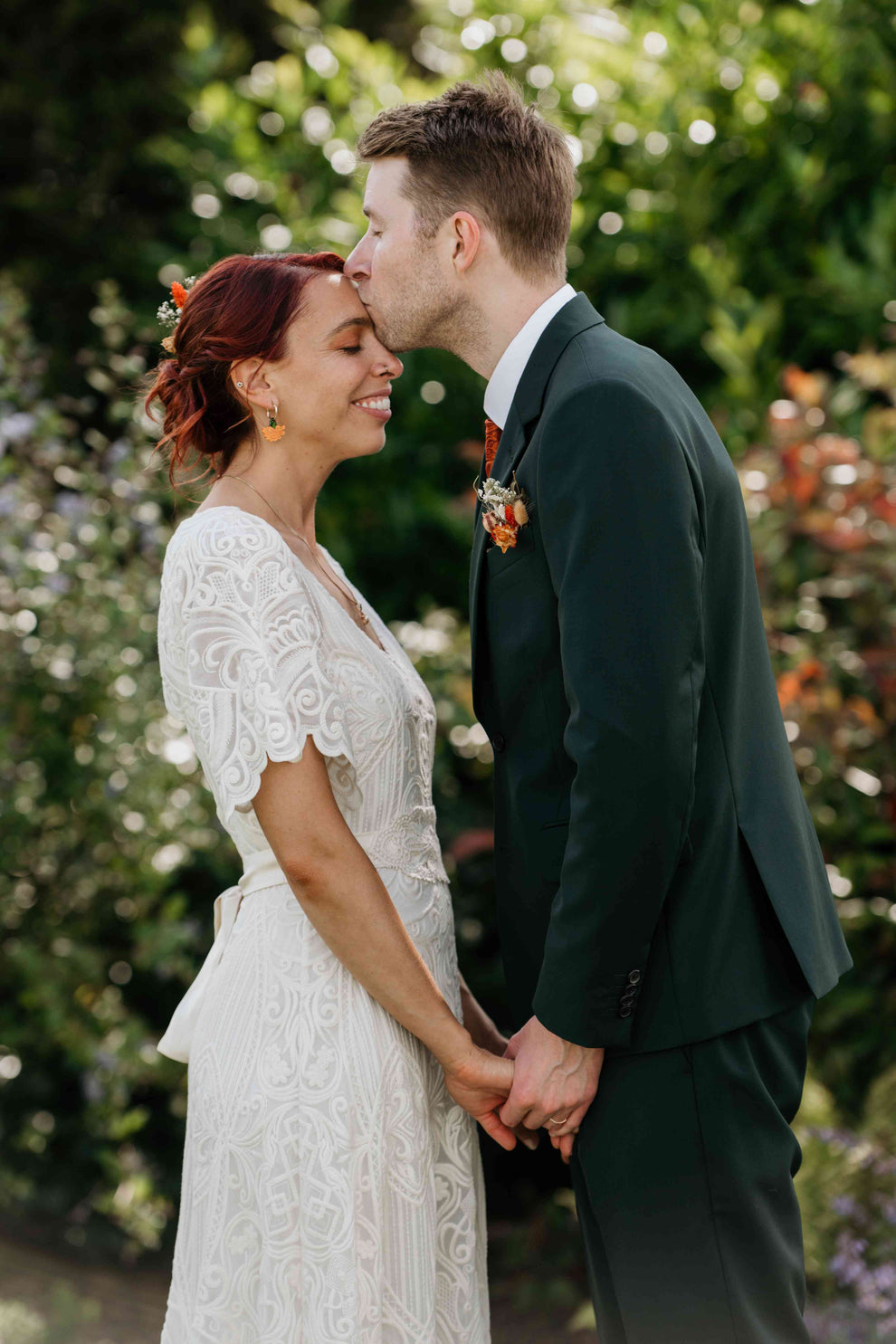 groom kissing bride on the forehead