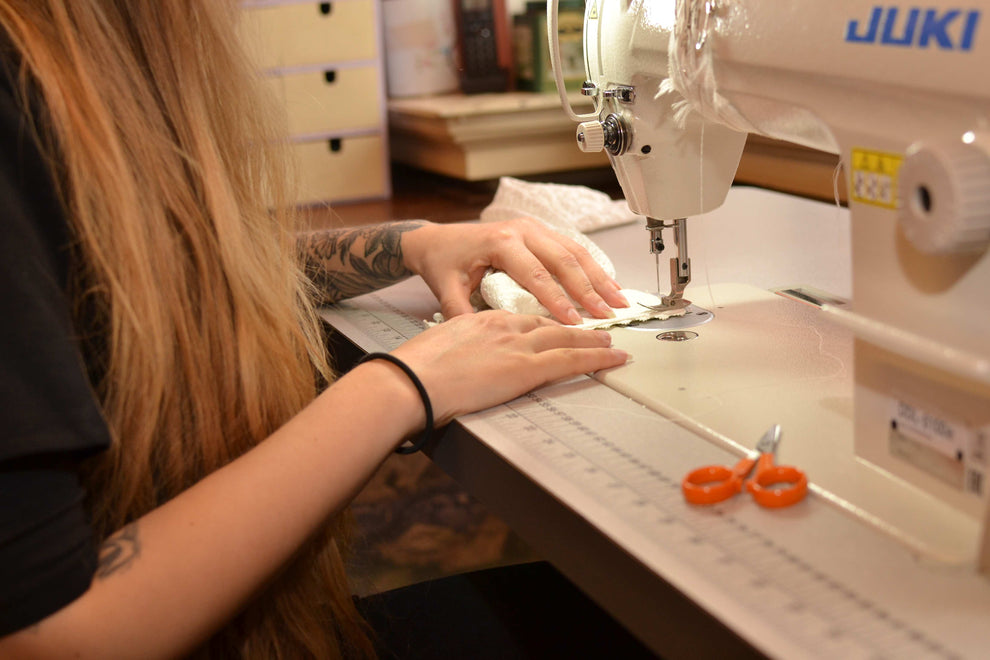 dress maker sewing a wedding dress