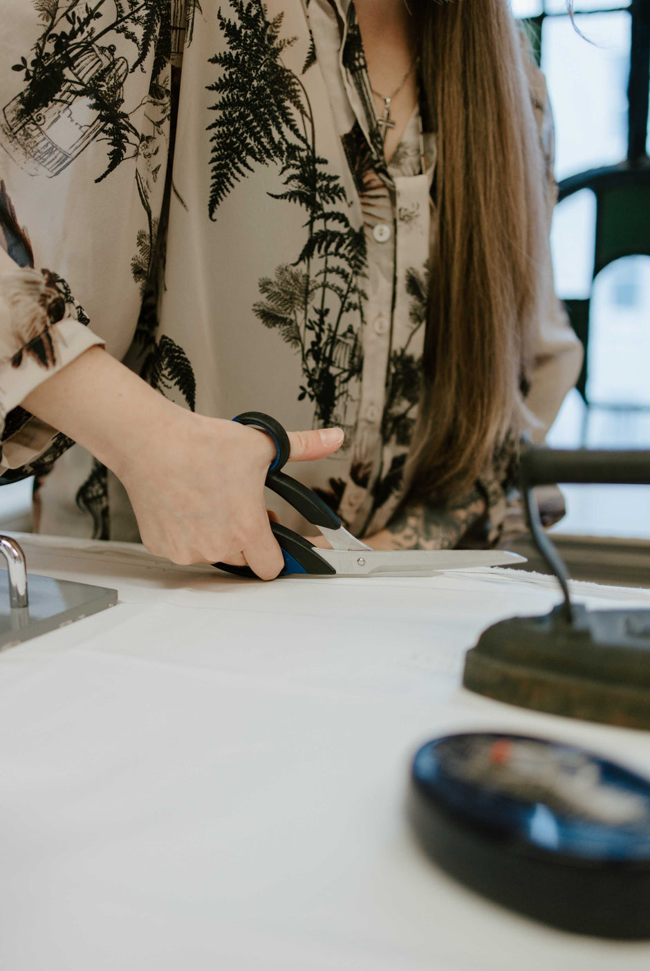 dressmaker cutting a wedding dress