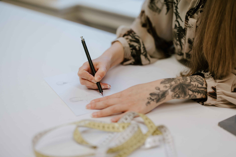 wedding dress designer sketching a wedding dress